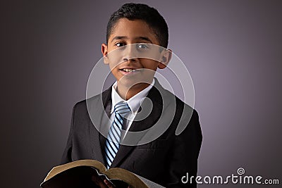 Little Hispanic Boy Holding the Holy Scriptures, The Word of God, The Bible Stock Photo