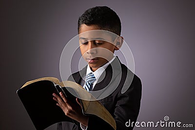 Little Hispanic Boy Reading the Holy Scriptures, The Bible, The Word of God Stock Photo