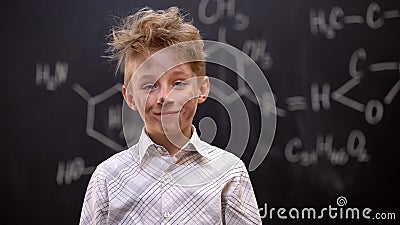 Little hooligan making explosion on chemistry lesson, naughty boy in school Stock Photo