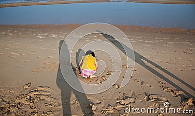 Little hurt child and parents shade on the beach Stock Photo