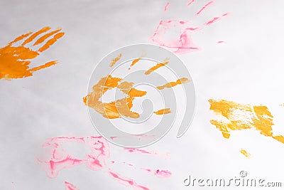 A little imprint of children`s hands on a white paper background, multi-colored hands Stock Photo