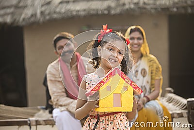 Little indian girl holding dream house model Stock Photo