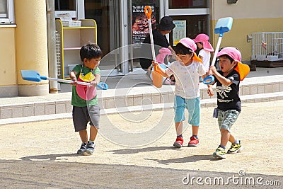 June 2018, Little Japanese boys playing scoops playground outdoors, Takayama, Japan Editorial Stock Photo