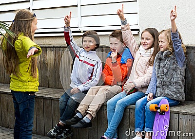 Little kid acting out phrase to friends Stock Photo