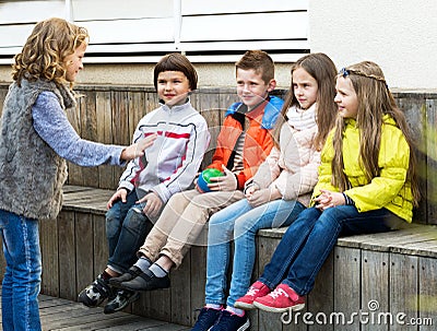 Little kid acting out phrase to friends Stock Photo