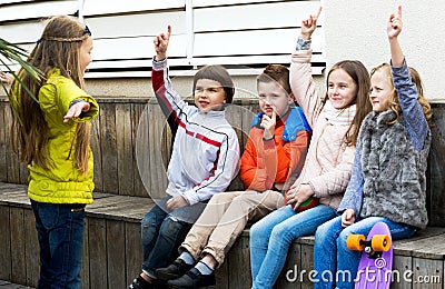 Little kid acting out phrase to friends Stock Photo