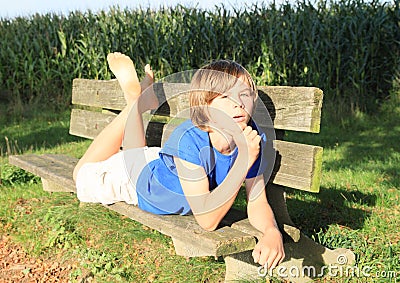 Little kid - boy on a bench Stock Photo