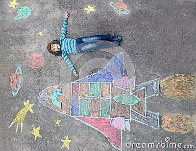 Little kid boy flying by a space shuttle chalks picture Stock Photo