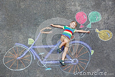 Little kid boy having fun with bike chalks picture Stock Photo