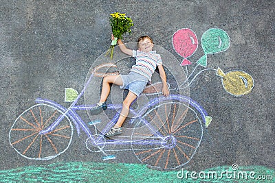 Little kid boy having fun with bike chalks picture Stock Photo