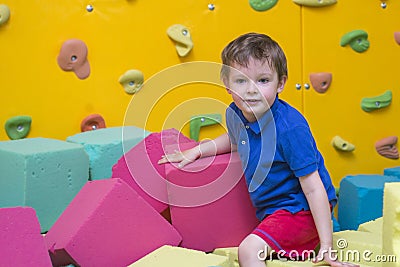 Little kid play with soft blocks at indoor children playground Stock Photo