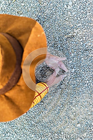 Little kid playing on the ground with the dirt and sand Stock Photo