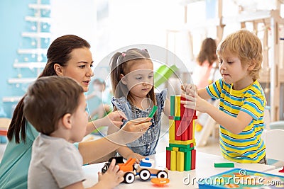 Little kids build block toys at home or daycare. Kids playing with color blocks. Educational toys for preschool and kindergarten Stock Photo