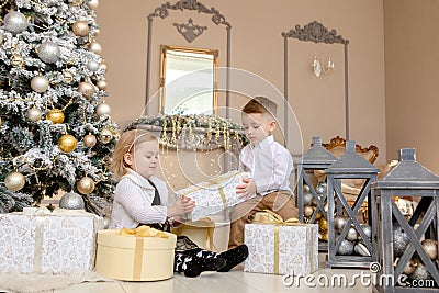 Little kids friendship and love. Little boy giving a little girl a gift. Present for a birthday, valentine`s day or other holiday Stock Photo