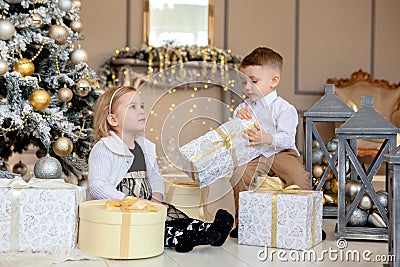 Little kids friendship and love. Little boy giving a little girl a gift. Present for a birthday, valentine`s day or other holiday Stock Photo