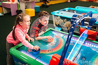 Little kids plays air hockey, entertainment center Stock Photo