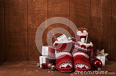 Little knitted boots with Christmas gifts and various decorations Stock Photo