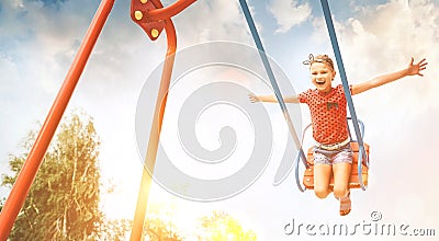 Little laughing girl swing on swing. Happy childchood concept image Stock Photo