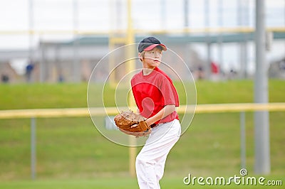 Youth baseball pitcher in red jersey Stock Photo