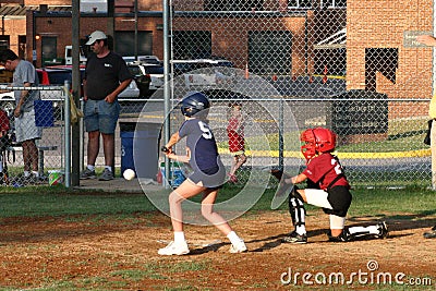 Little League player swings at softball Editorial Stock Photo