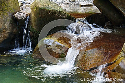Little marvellous waterfall among the rocks of mountain creek Stock Photo