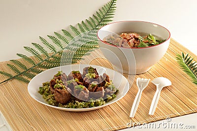 little meatballs with green chili sauce in a plate and gravy in a bowl Stock Photo