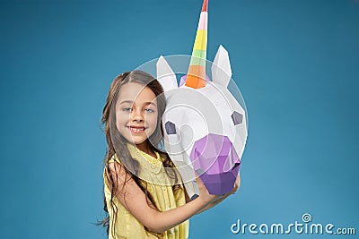 Little model posing with white 3D unicorm. Stock Photo