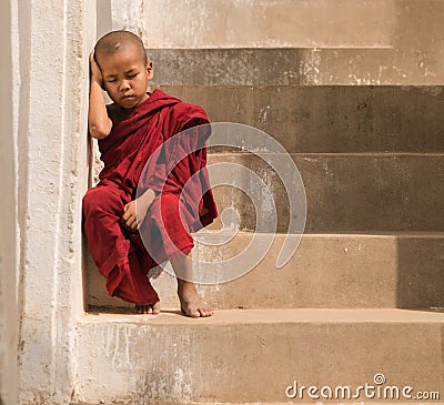 Little monk stay in pagoda Mandalay,Myanmar. Little monk or novice monk sitting in pagoda mandalay myanmar. Stock Photo