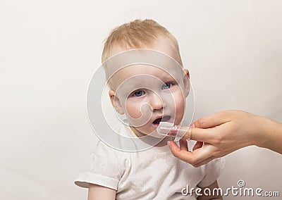 Little mother cleaning her teeth, white background, close up mother Stock Photo