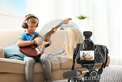 Little music teacher recording guitar lesson Stock Photo