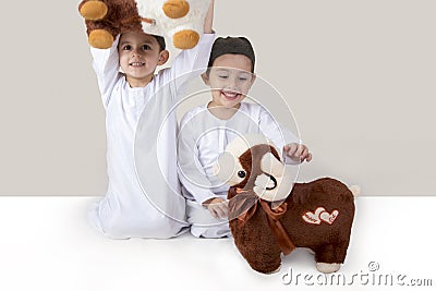 Little Muslim kids playing with sheep toys Stock Photo