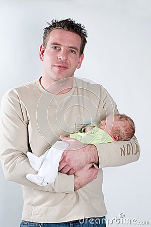 Little newborn baby beeing held by his father Stock Photo