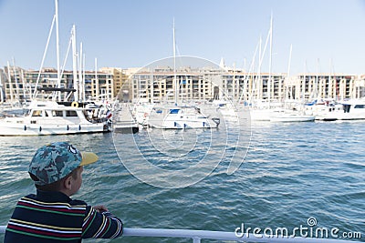 Little boy in the Old Port of Marseille Stock Photo