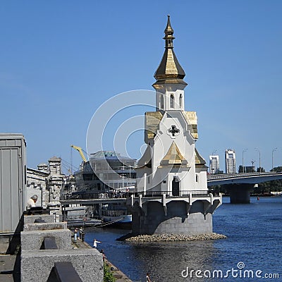 Little orthodox chapel on the river bank, bridge over the river, church on the water Stock Photo