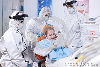 Little patient holds mirror in the course of oral hygine treatment Stock Photo