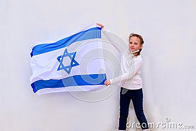 Little patriot jewish girl with the flag of Israel on white background. Stock Photo