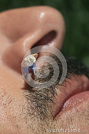 Little People Mowing Hair off a Mans Face Stock Photo