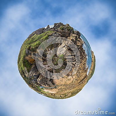 Little planet of grass, rocks and ocean Stock Photo