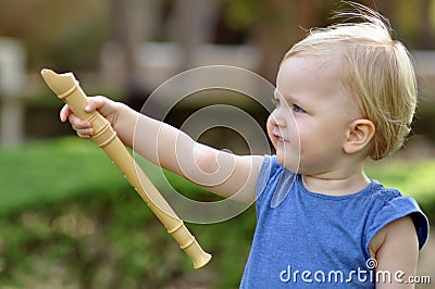 Little pointing girl in blue dress in park Stock Photo