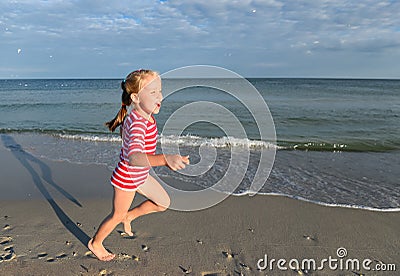 Little pretty girl on summer beach. Little blond girl runs along the beach and have fun Stock Photo