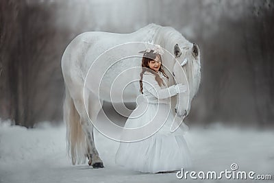 The little princess with an unicorn in the forest. Stock Photo