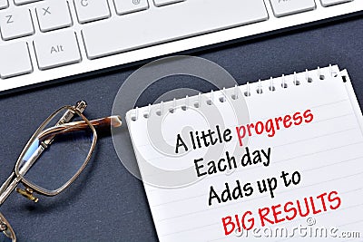 A little progress Each day Adds up to Big Results text on notebook page Stock Photo