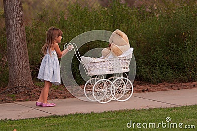 Little pushing toy baby buggy which is white wicker Stock Photo