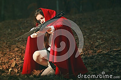 Little red riding hood aiming with crossbow Stock Photo