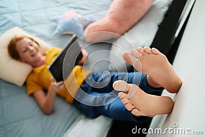 Little Redhead Girl Watching Cartoons At Home With Tablet Stock Photo