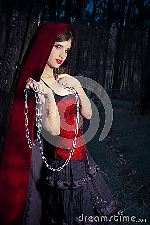 Little Riding Red Hood standing in the woods Stock Photo