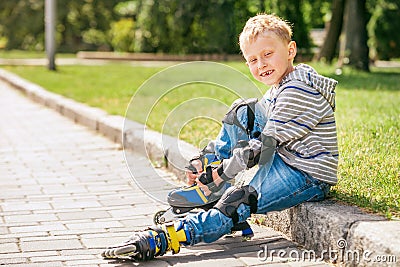 Little roller skater put on his skates Stock Photo