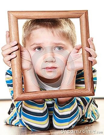 Little sad boy child framing his face Stock Photo