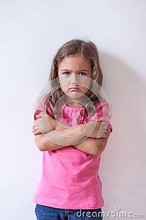 Little Sad Girl With Expression Face In On White Wall Background Stock Photo