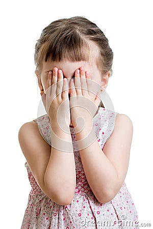 Little scared or crying or playing bo-peep kid hiding face Stock Photo